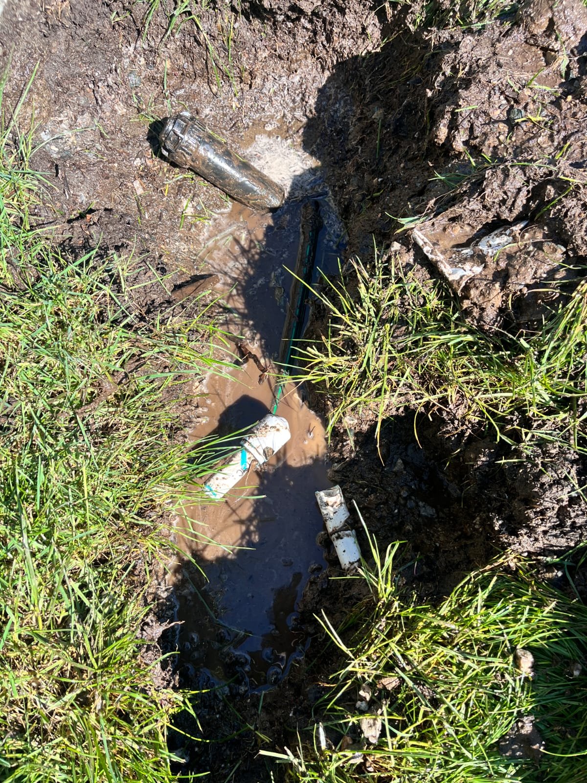 Technician repairing a lawn irrigation system